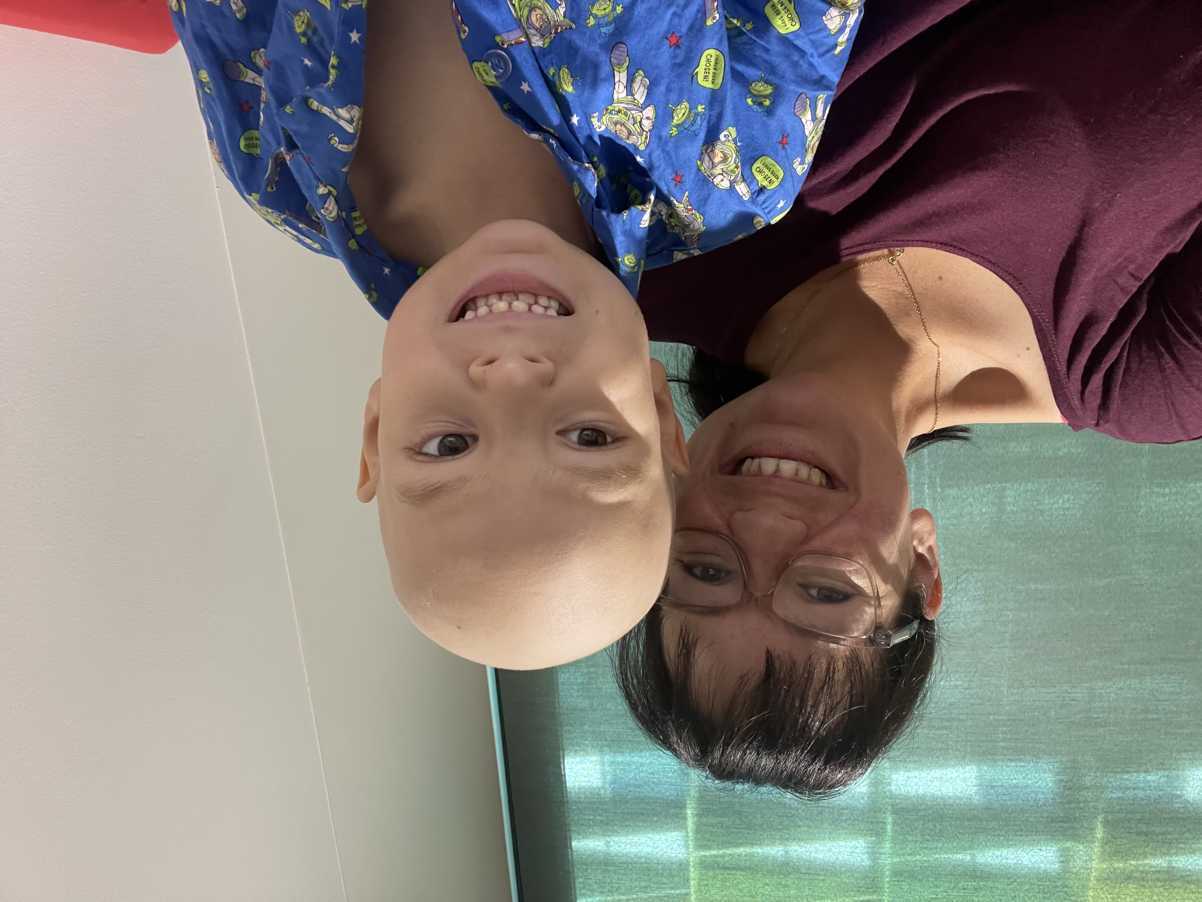 Photo of mum and son in hospital shortly after losing hair to chemo