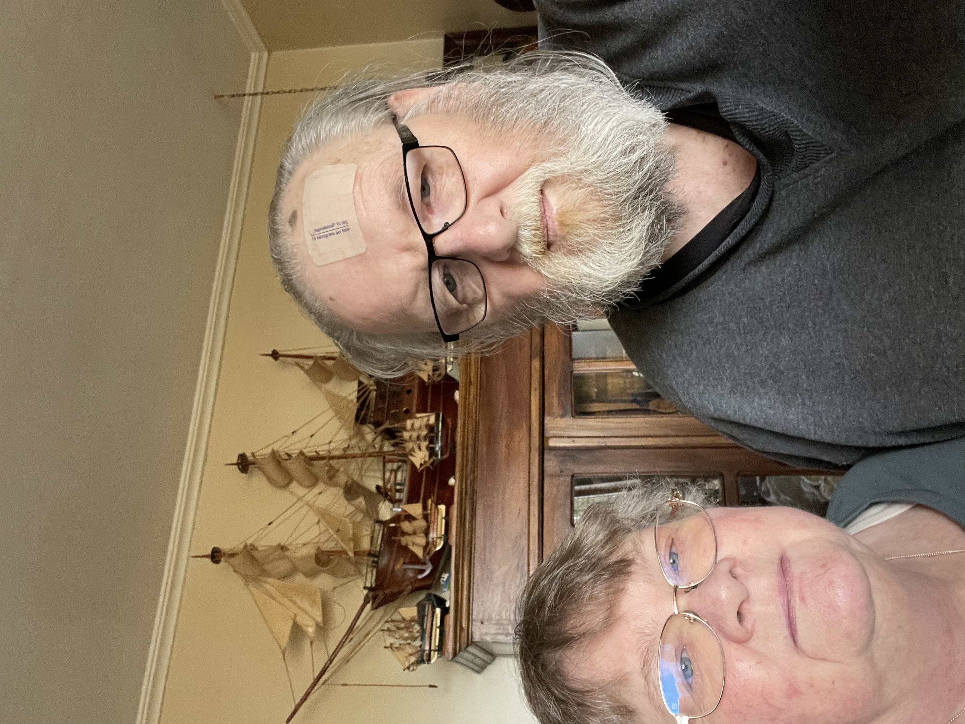 Photo of man and woman/carer in their living room