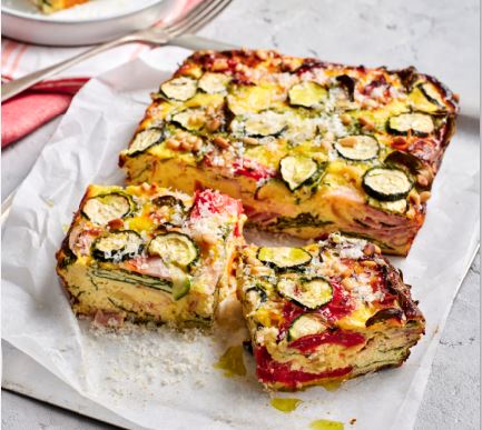 Ham and vegetable frittata on a baking paper sheet