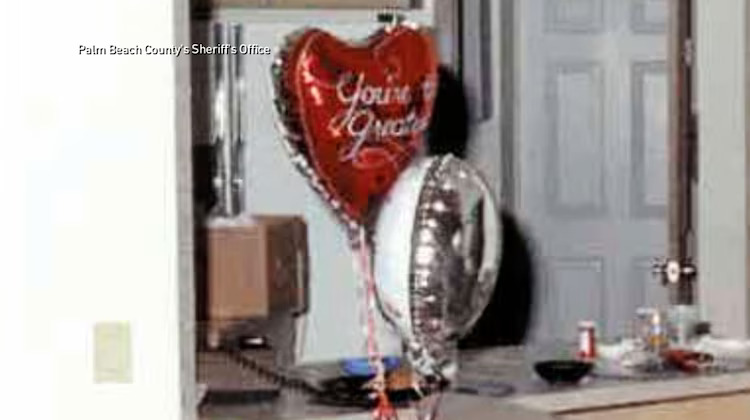 red heart balloon and silver foil balloon on doorstep