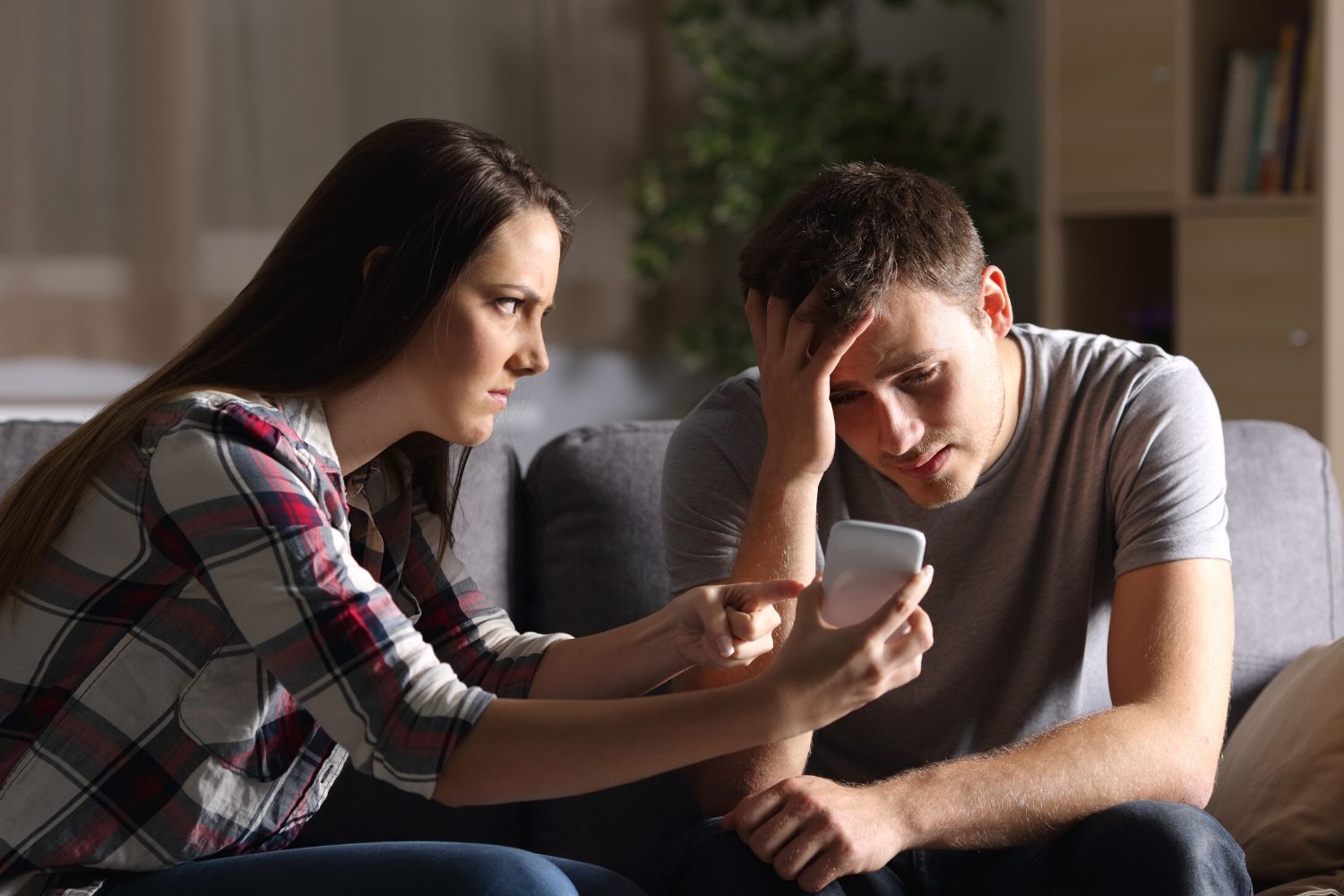 Woman looking at boyfriend's phone