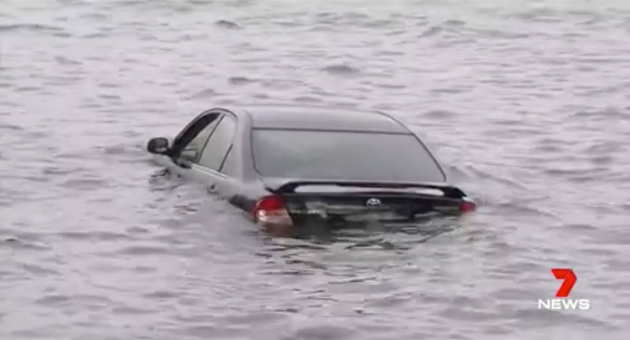 Driver crashes car into a river after looking away to check the GPS ...